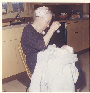 My great grandmother holding me in my grandmother's kitchen in 1961.